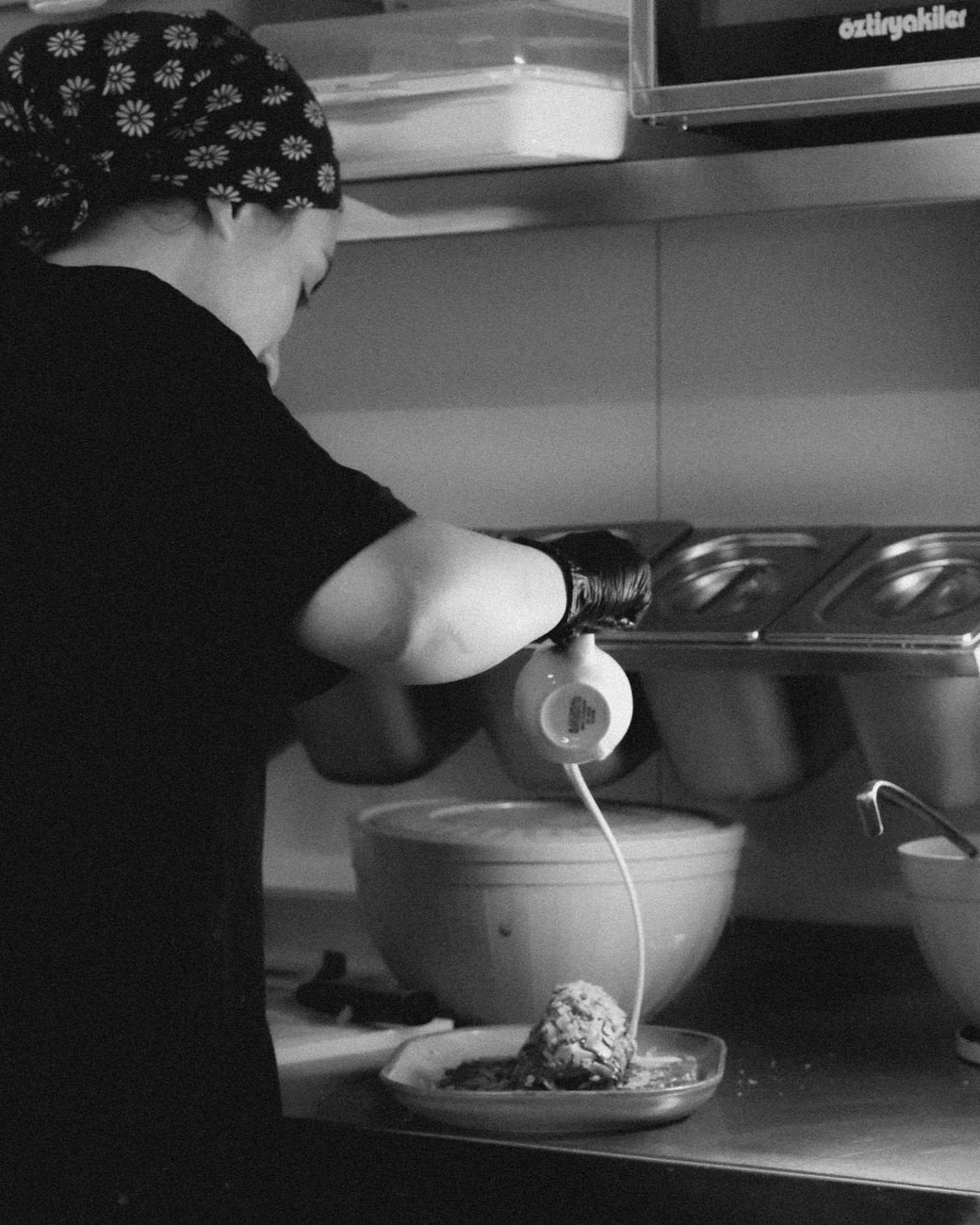 A chef at work, carefully plating with precision in a professional kitchen